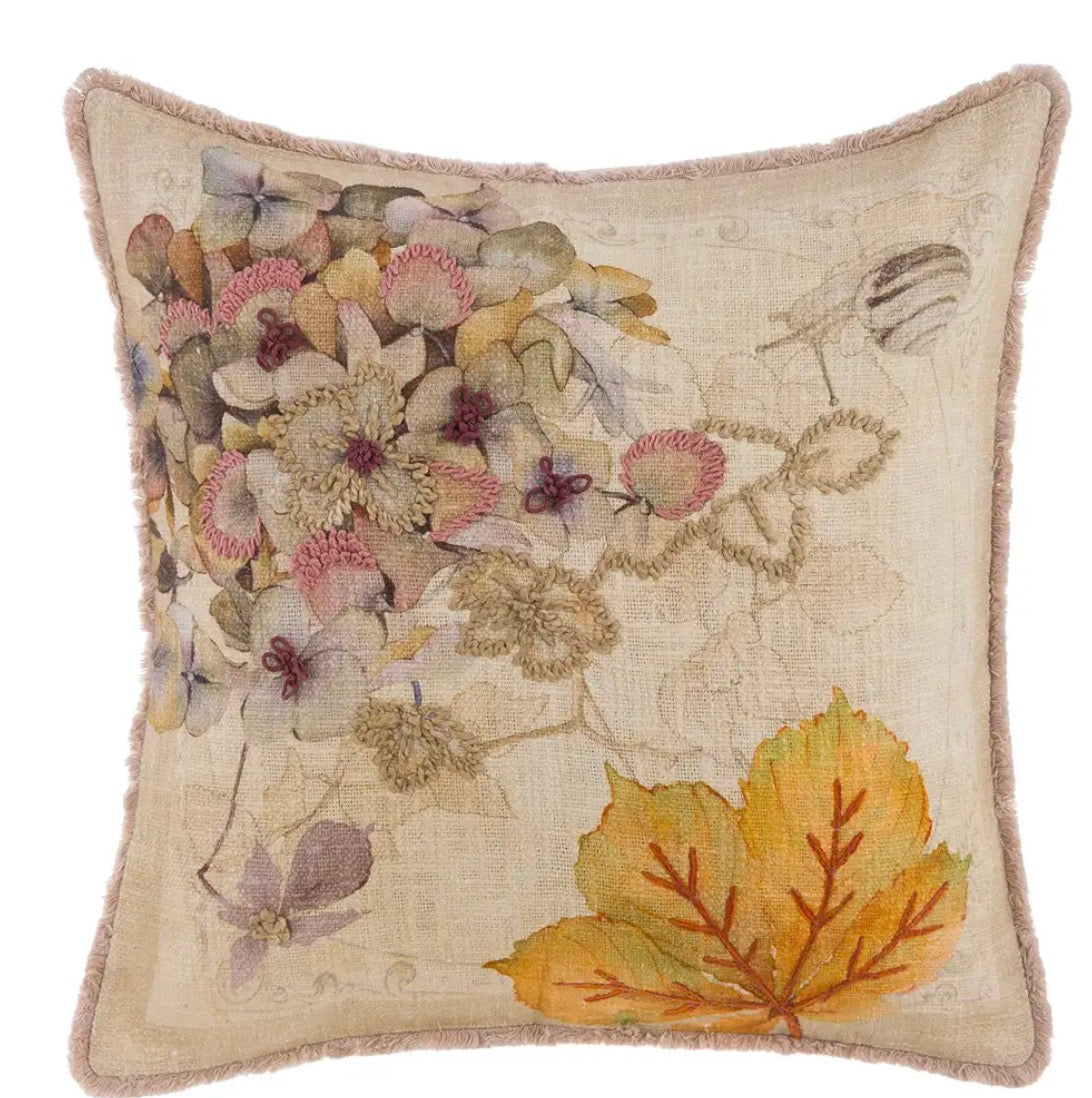 Cuscino stampato e ricamato "Promenade" con design botanico di fiori e foglie su base chiara in cotone.